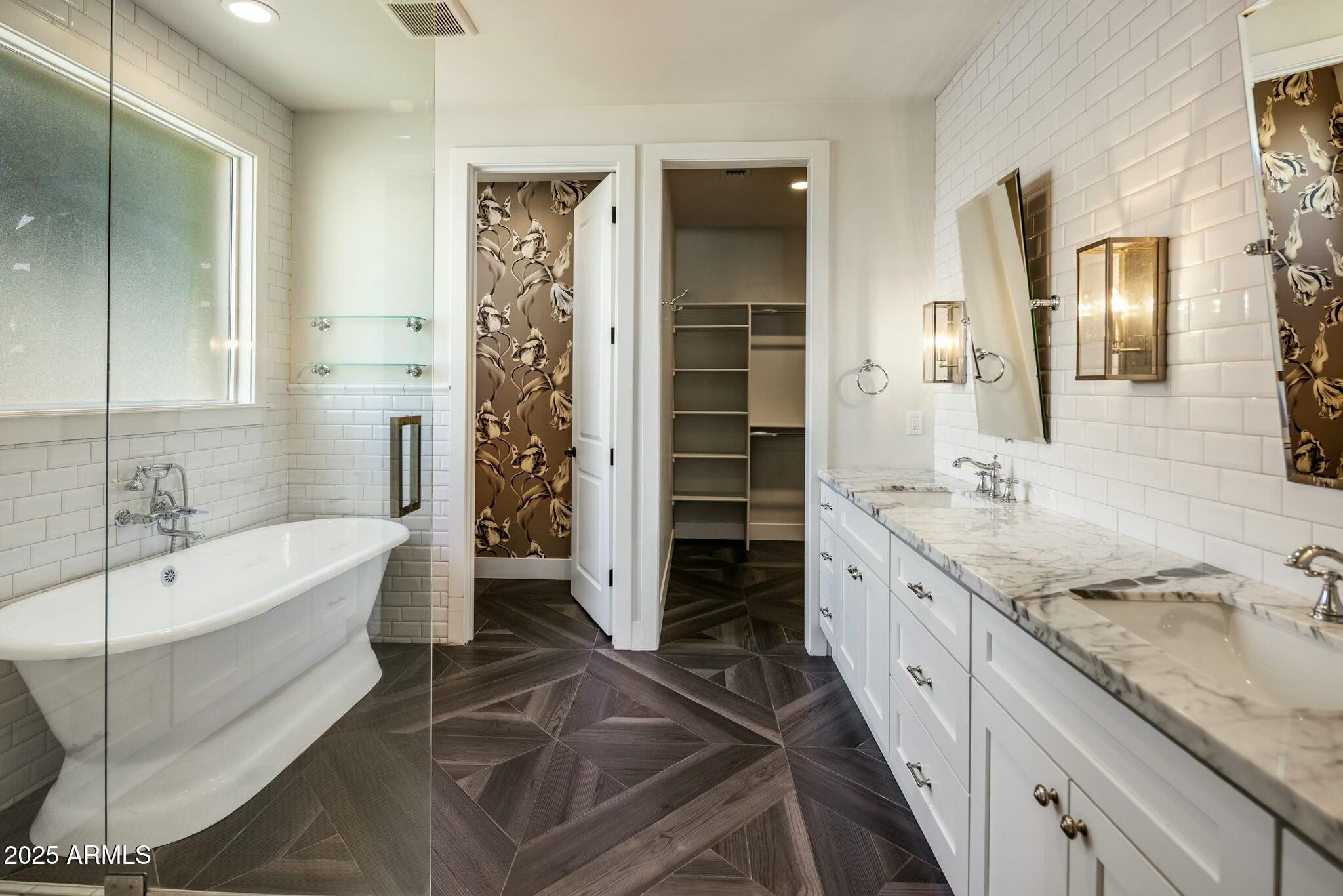 3902 East Fairmount Avenue Phoenix, AZ 85018 - Photo 14 of 32 a spacious bathroom with a granite countertop tub sink a mirror and shower
