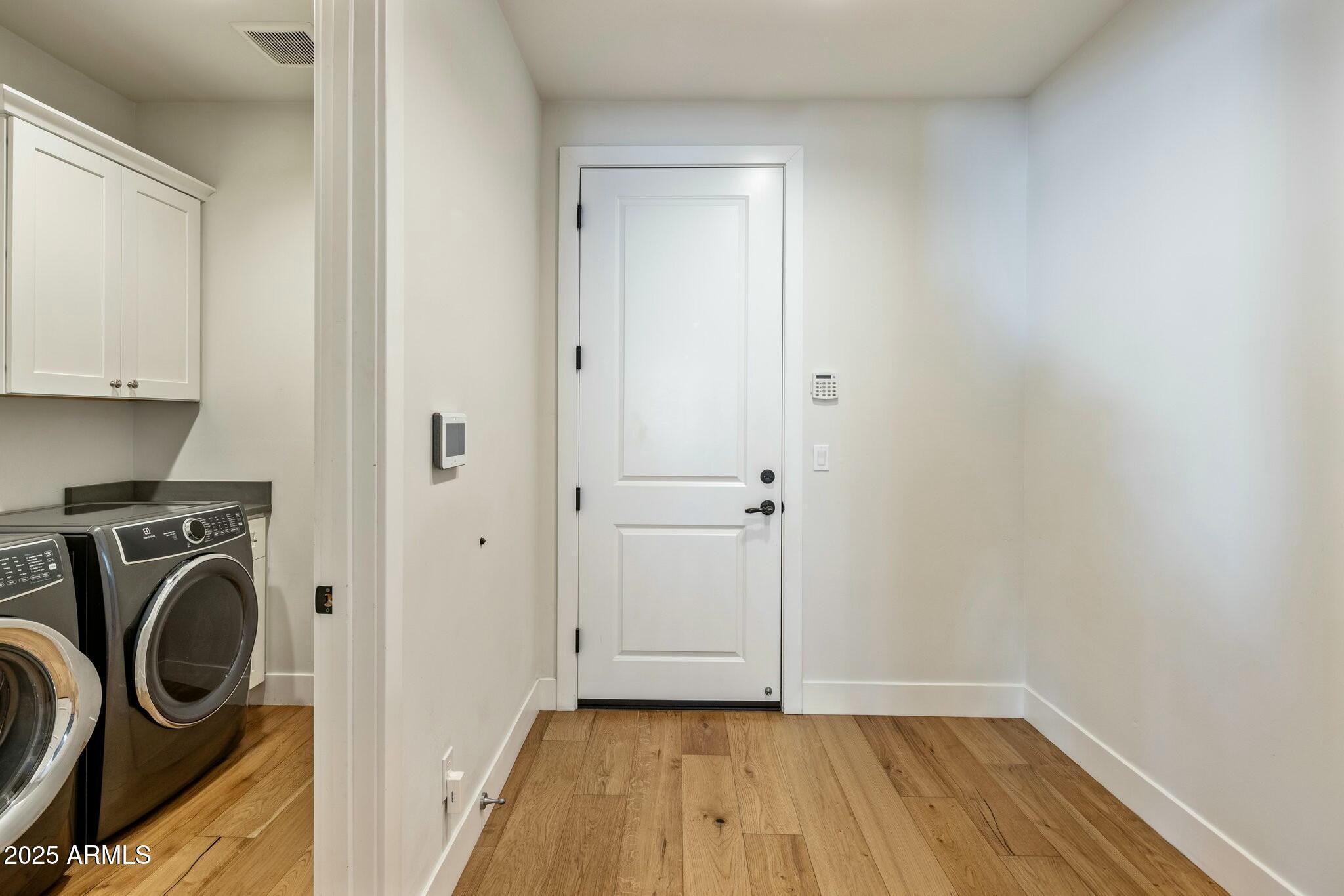 3902 East Fairmount Avenue Phoenix, AZ 85018 - Photo 21 of 32 a view of walk in closet with wooden floor