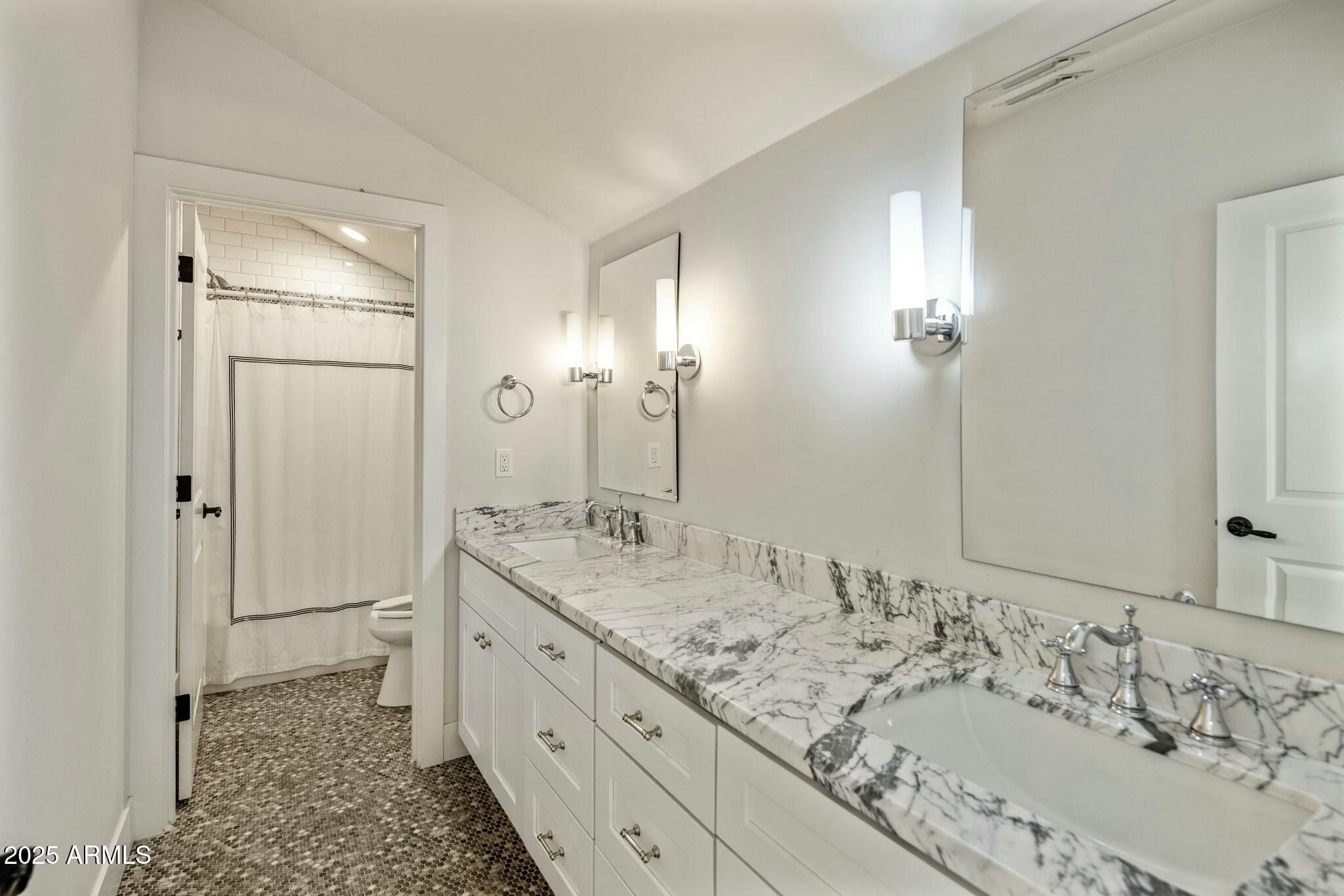 3902 East Fairmount Avenue Phoenix, AZ 85018 - Photo 27 of 32 a bathroom with a sink double vanity and a mirror