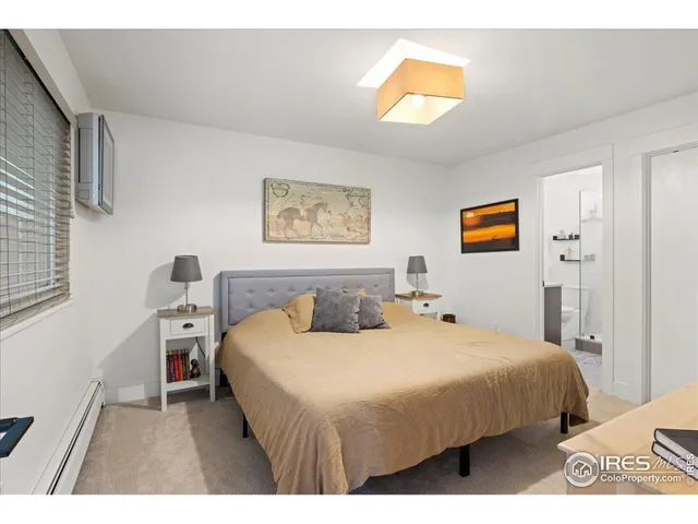a bathroom with a granite countertop toilet sink and mirror