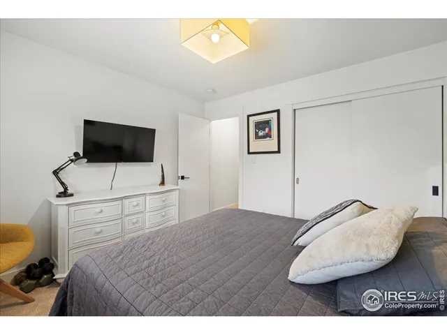 a bedroom with a bed and a television