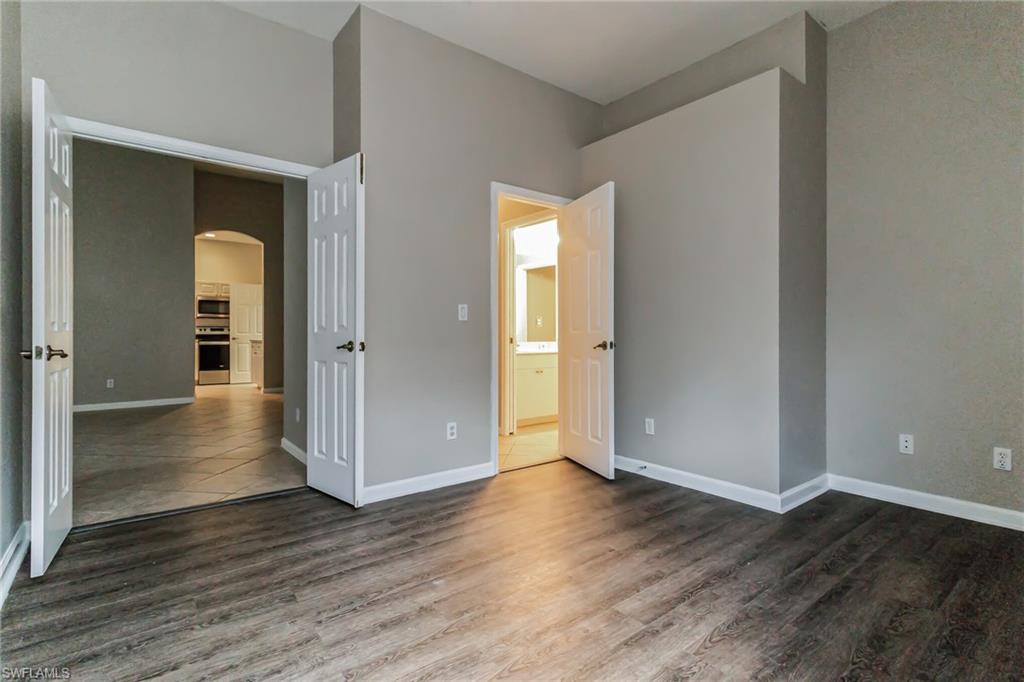 7849 Founders Lane Naples, FL 34104 - Photo 16 of 23 an empty room with wooden floor & closet area