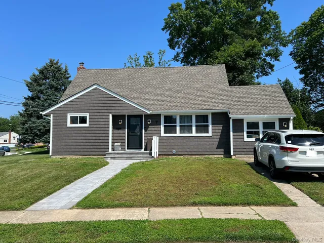 a front view of a house with a garden and porch