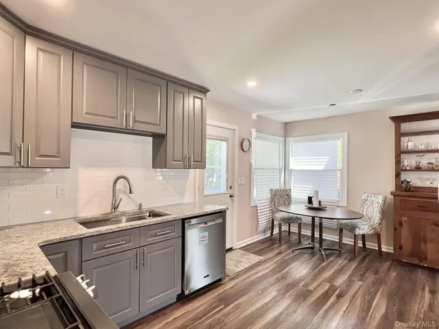 a kitchen with sink cabinets and wooden floor