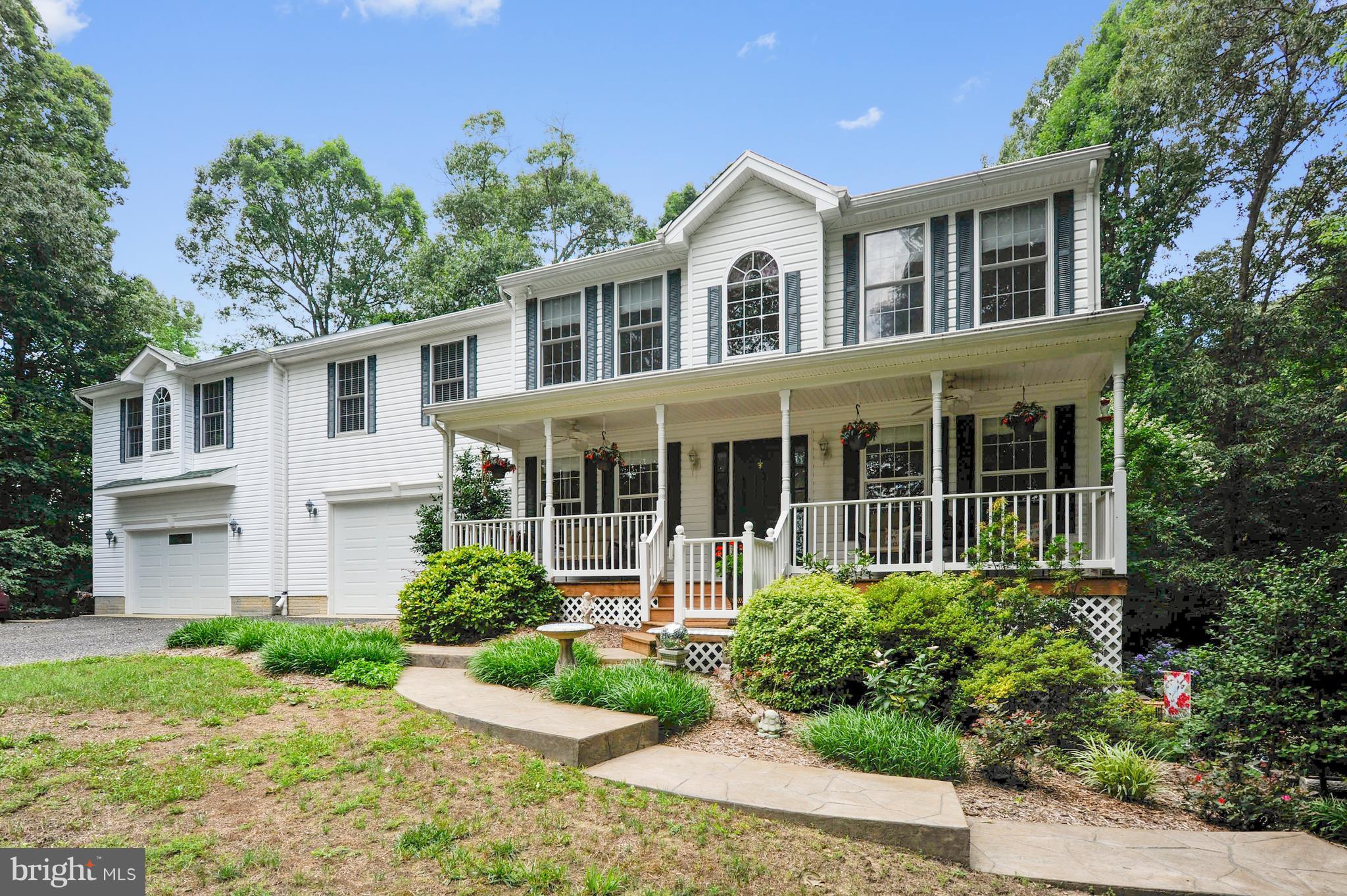 2816 Stinnett Road Huntingtown, MD 20639 - Photo 2 of 27 a front view of a house with garden and porch