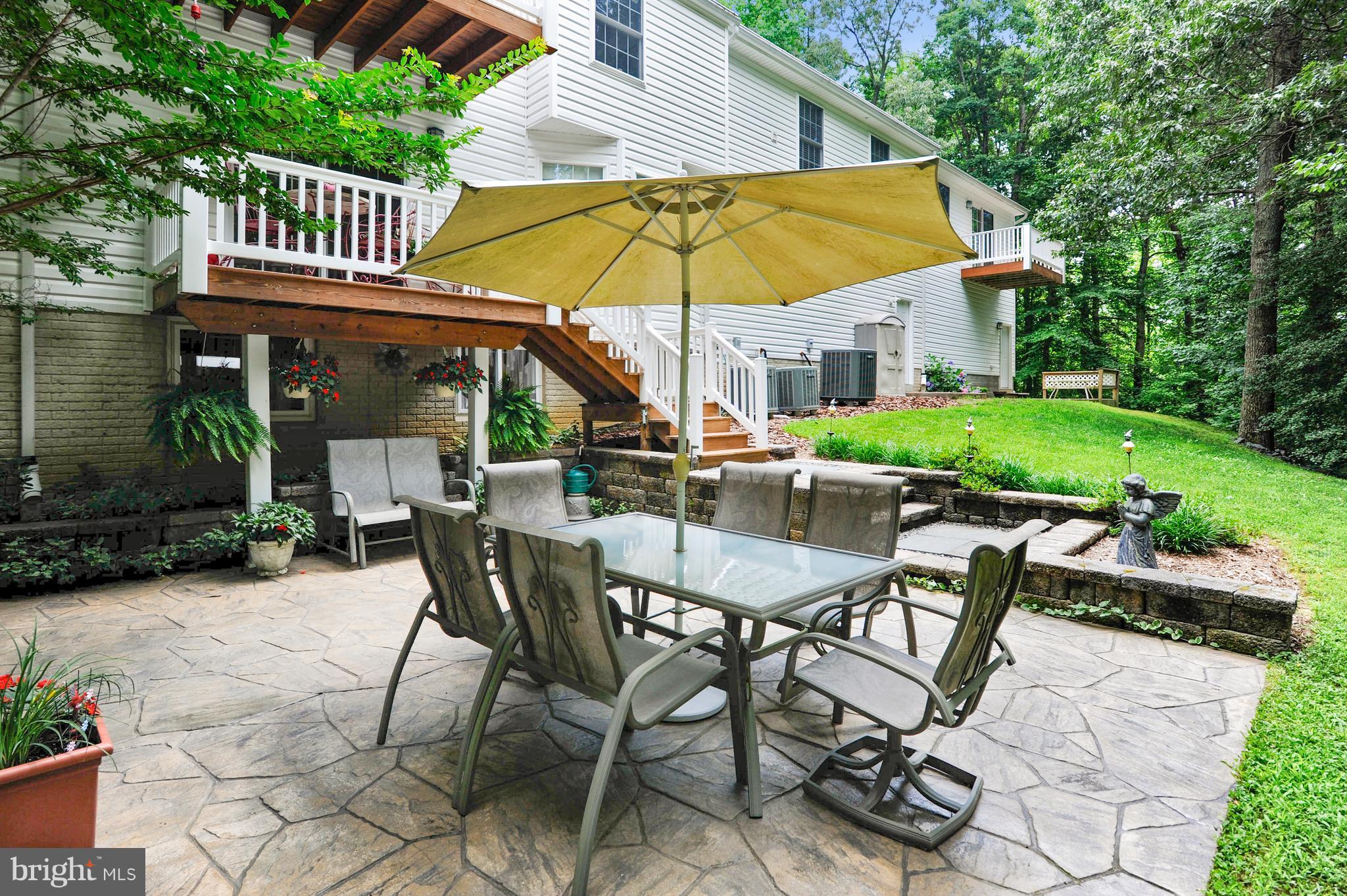 2816 Stinnett Road Huntingtown, MD 20639 - Photo 17 of 27 a view of patio with chairs and table under an umbrella