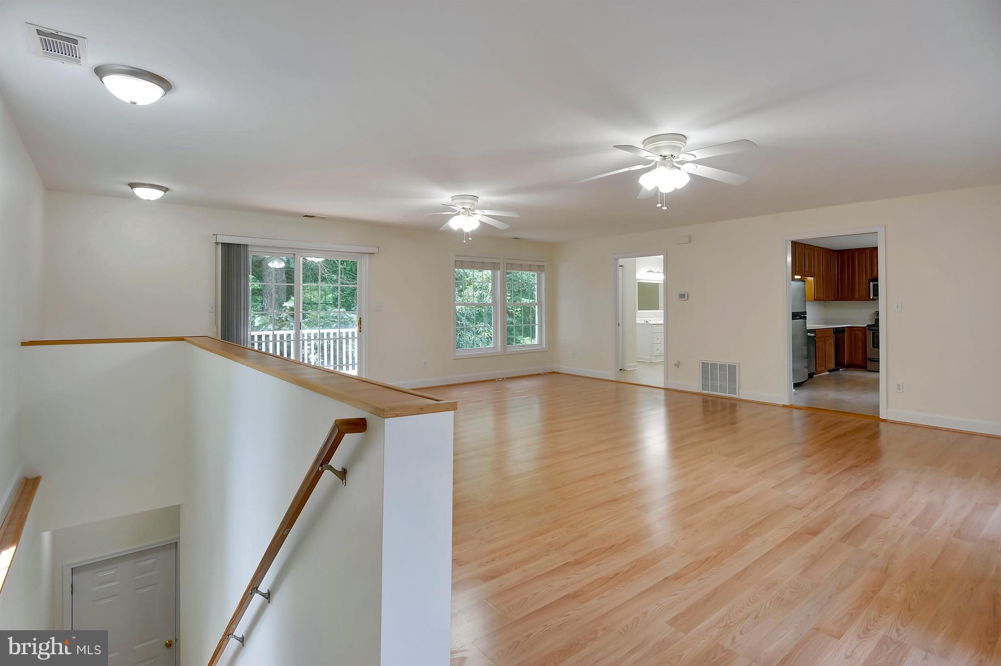 2816 Stinnett Road Huntingtown, MD 20639 - Photo 20 of 27 a view of an empty room with wooden floor and a window
