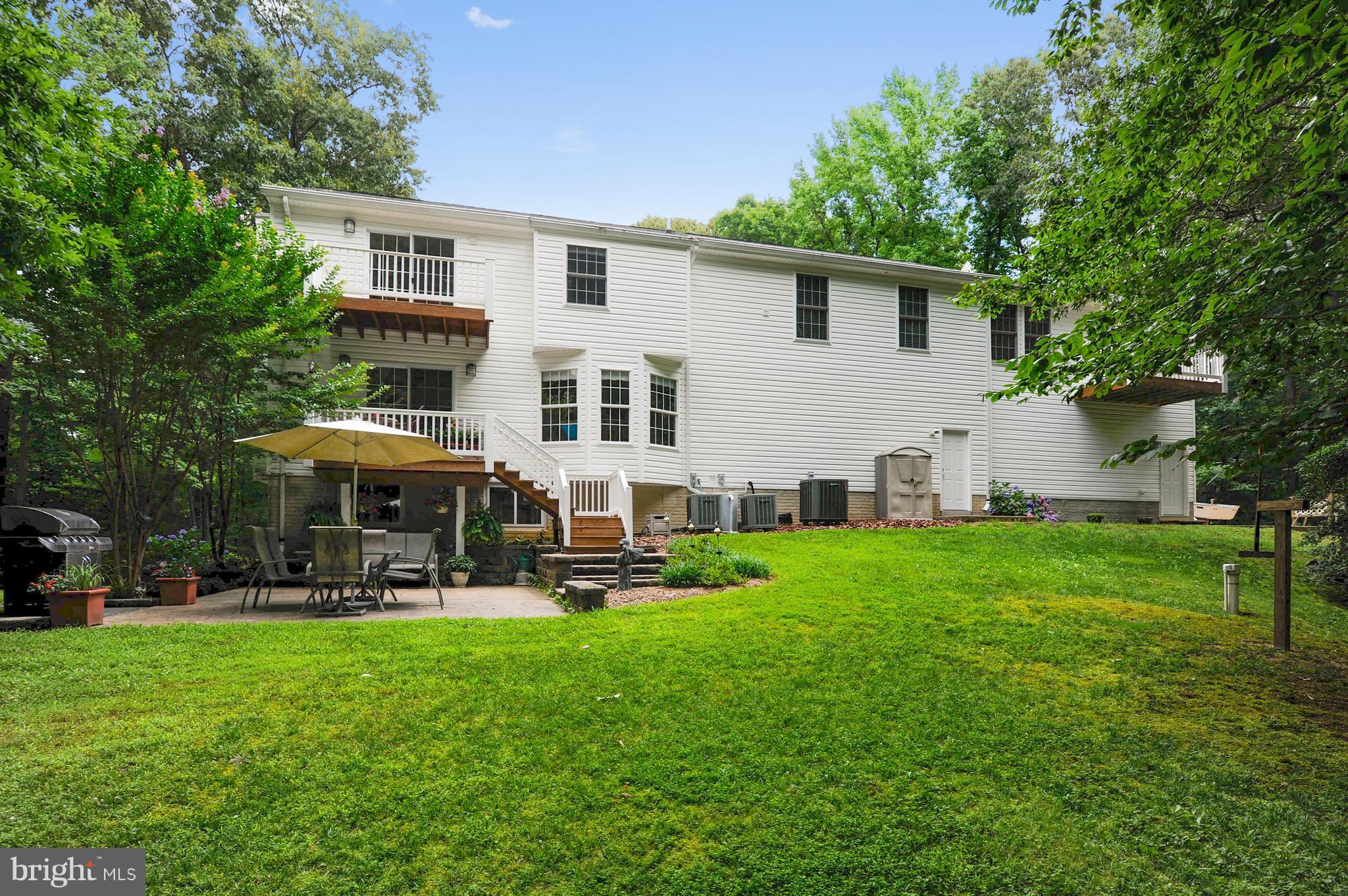 2816 Stinnett Road Huntingtown, MD 20639 - Photo 3 of 27 a front view of a house with garden and trees