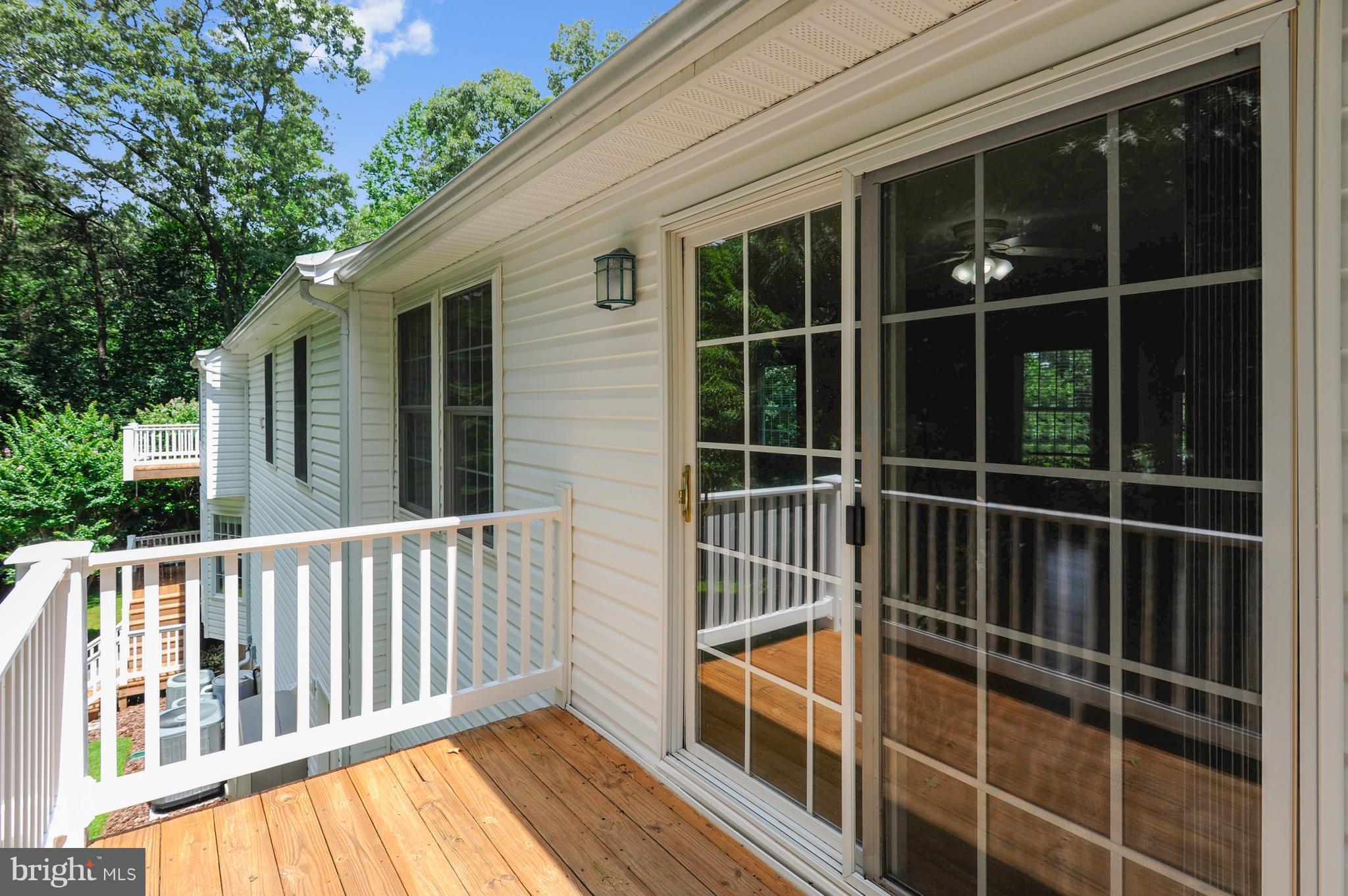 2816 Stinnett Road Huntingtown, MD 20639 - Photo 22 of 27 a view of a balcony with a floor to ceiling window and wooden floor