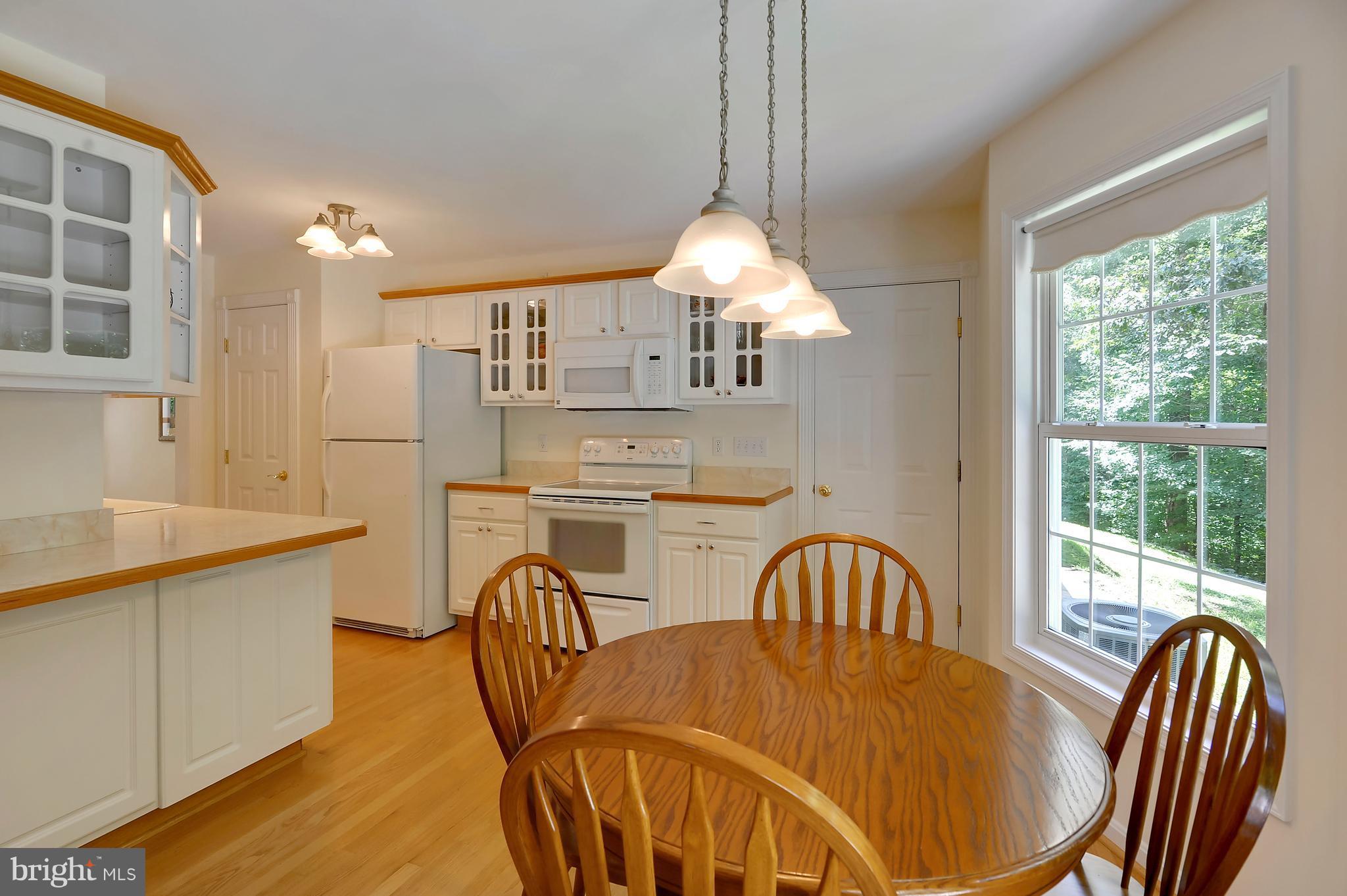 2816 Stinnett Road Huntingtown, MD 20639 - Photo 8 of 27 a view of a dining room with furniture window and outside view