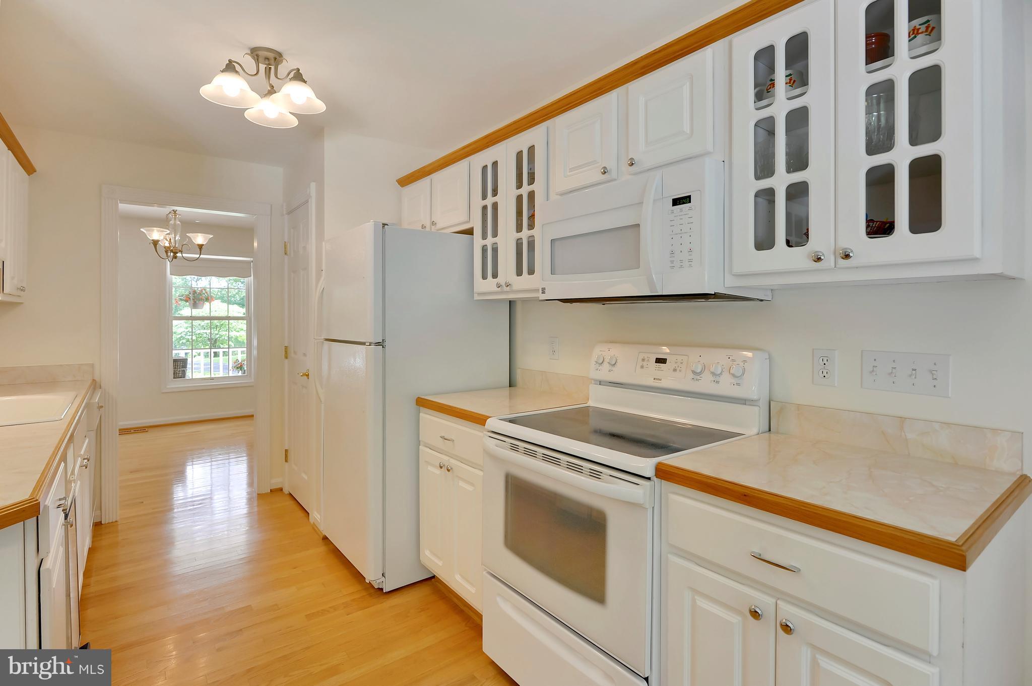 2816 Stinnett Road Huntingtown, MD 20639 - Photo 9 of 27 a kitchen with cabinets and wooden floor