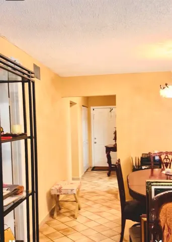 a bedroom with a bed and large windows