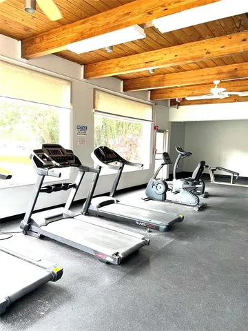 a room with gym equipment and a large window