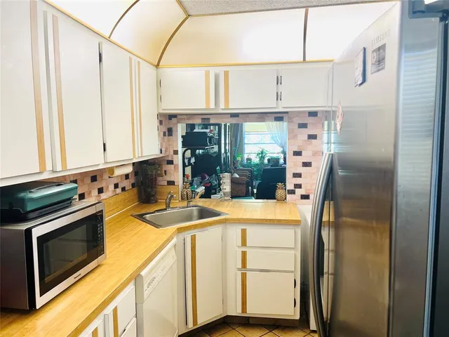 a kitchen with stainless steel appliances a refrigerator and a stove