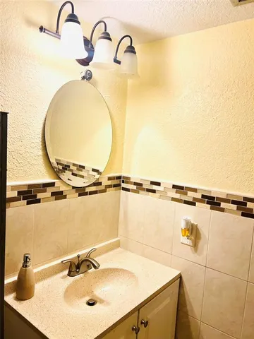 a bathroom with a sink and mirror