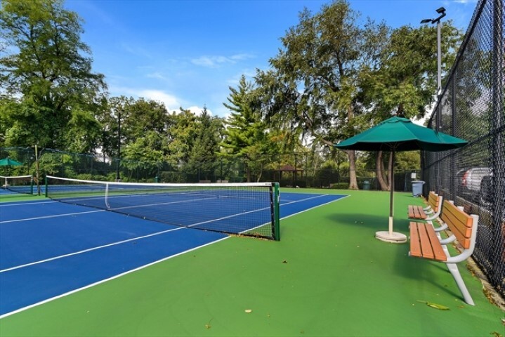 5700 Arlington Avenue, Unit 22N Bronx, NY 10471 - Photo 11 of 12 a view of a tennis ground with large trees