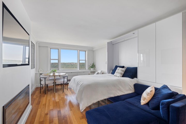 5700 Arlington Avenue, Unit 22N Bronx, NY 10471 - Photo 4 of 12 a bed room with a bed and a chair