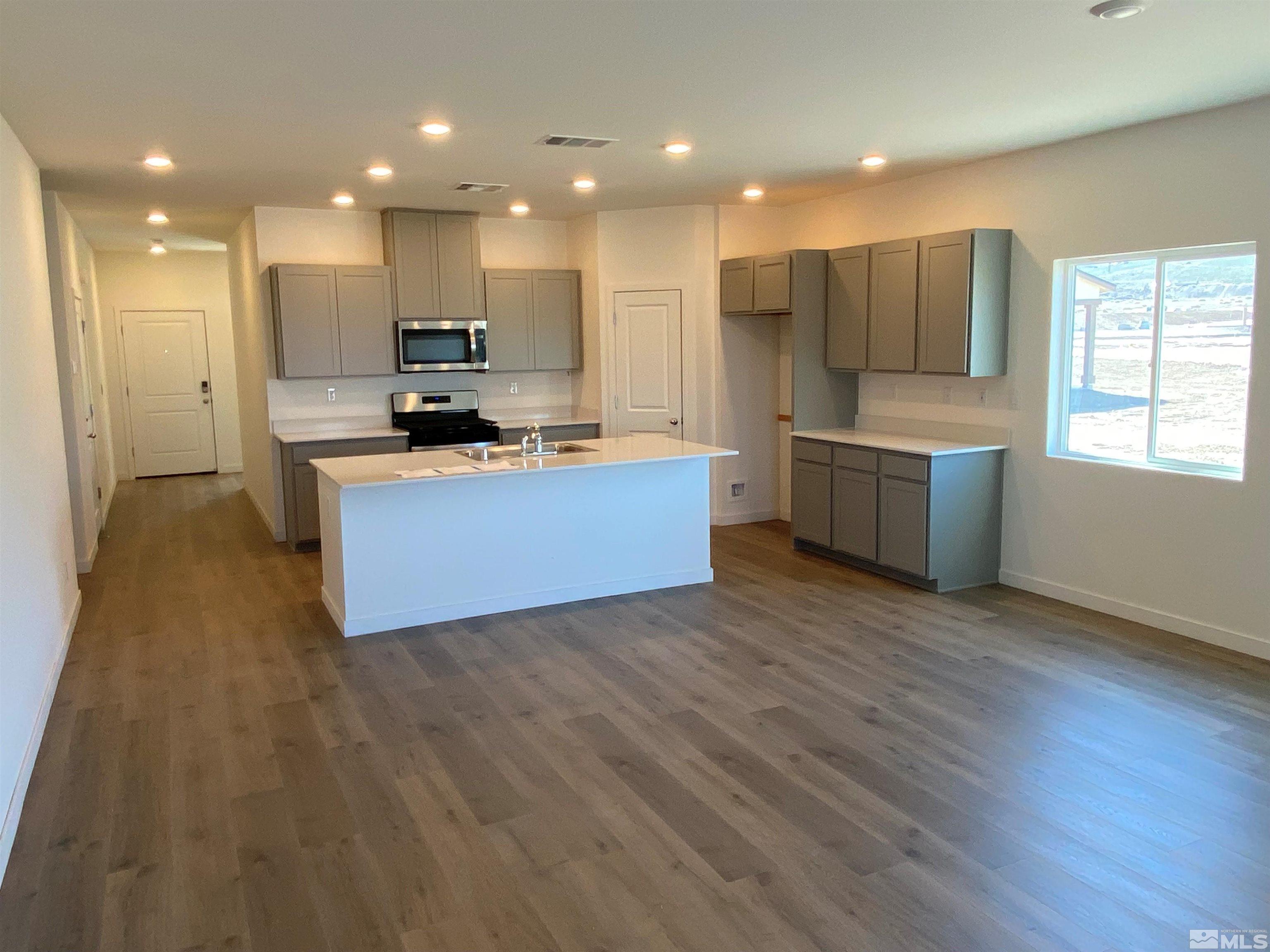 706 Ruby Valley Court, Unit LOT #56 Dayton, NV 89403 - Photo 2 of 2 a view of kitchen with kitchen island wooden floors stainless steel appliances and window