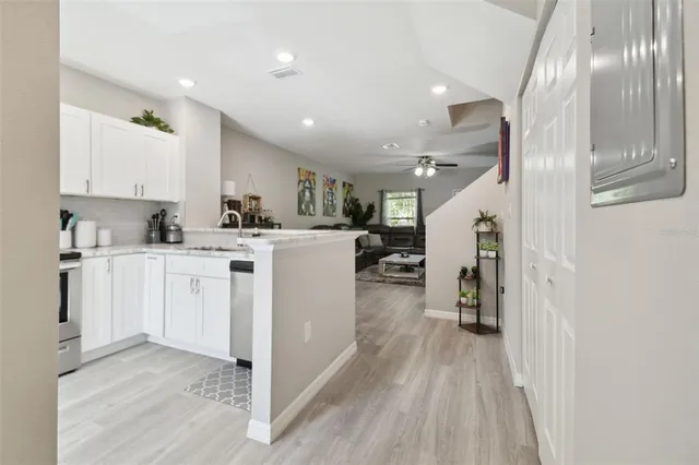 a view of kitchen with cabinets and wooden floor