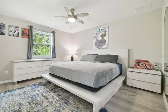 a bedroom with a white bed and a chandelier