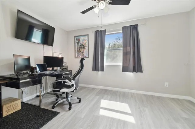 a view of a workspace with furniture and a flat screen tv