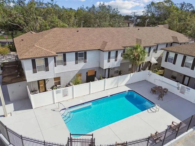 a aerial view of a house with a yard and furniture