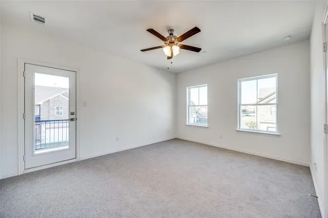 a view of empty room with ceiling fan