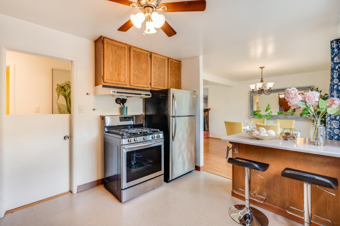 1376 Peralta Road Pacifica, CA 94044 - Photo 14 of 35 a kitchen with kitchen island stainless steel appliances a stove refrigerator and cabinets