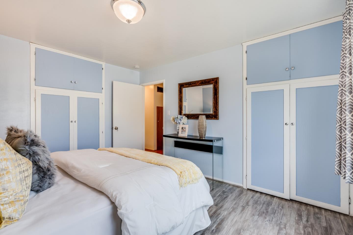 1376 Peralta Road Pacifica, CA 94044 - Photo 17 of 35 a bedroom with a bed and wooden floor