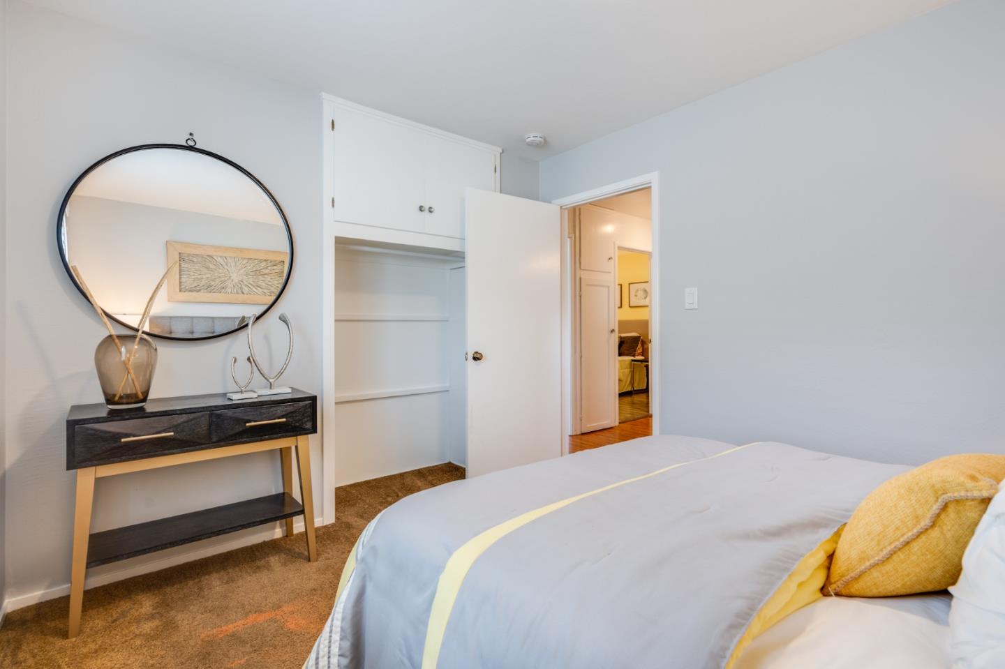 1376 Peralta Road Pacifica, CA 94044 - Photo 22 of 35 a bedroom with a bed and a mirror