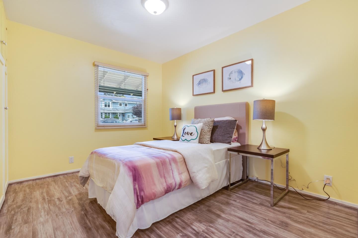 1376 Peralta Road Pacifica, CA 94044 - Photo 23 of 35 a bedroom with a bed and wooden floor