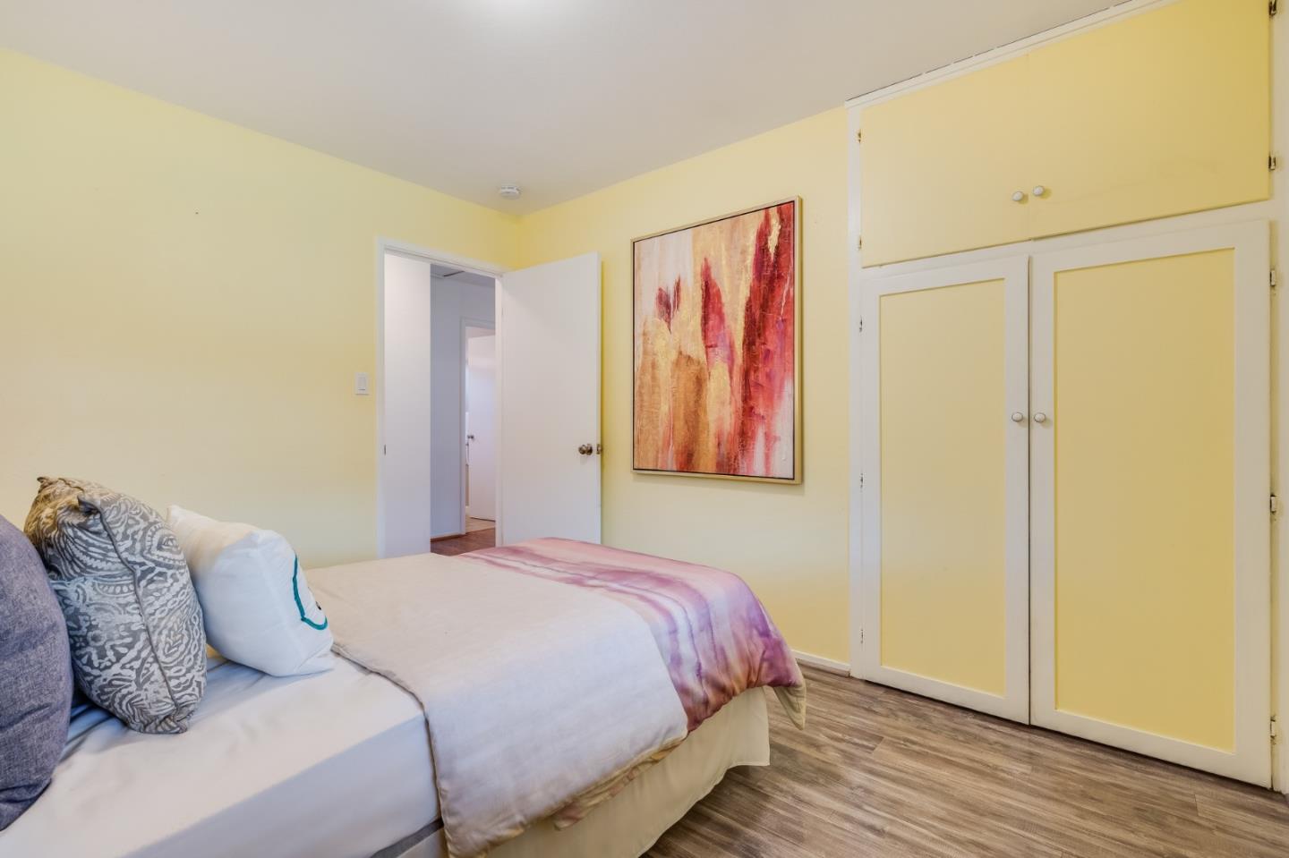 1376 Peralta Road Pacifica, CA 94044 - Photo 24 of 35 a bedroom with a bed and wooden floor