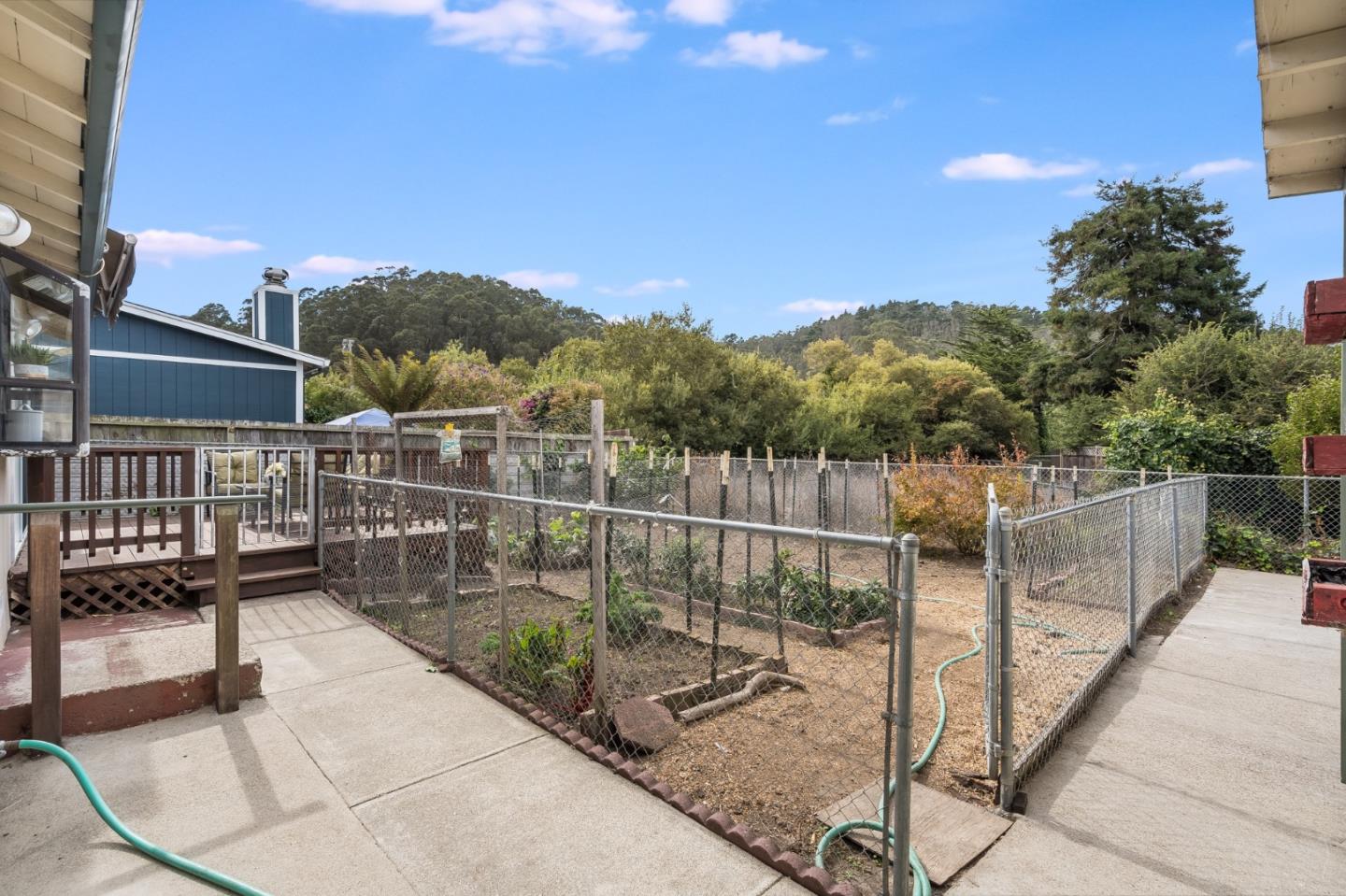 1376 Peralta Road Pacifica, CA 94044 - Photo 28 of 35 a view of a balcony with a floor to ceiling window and wooden fence