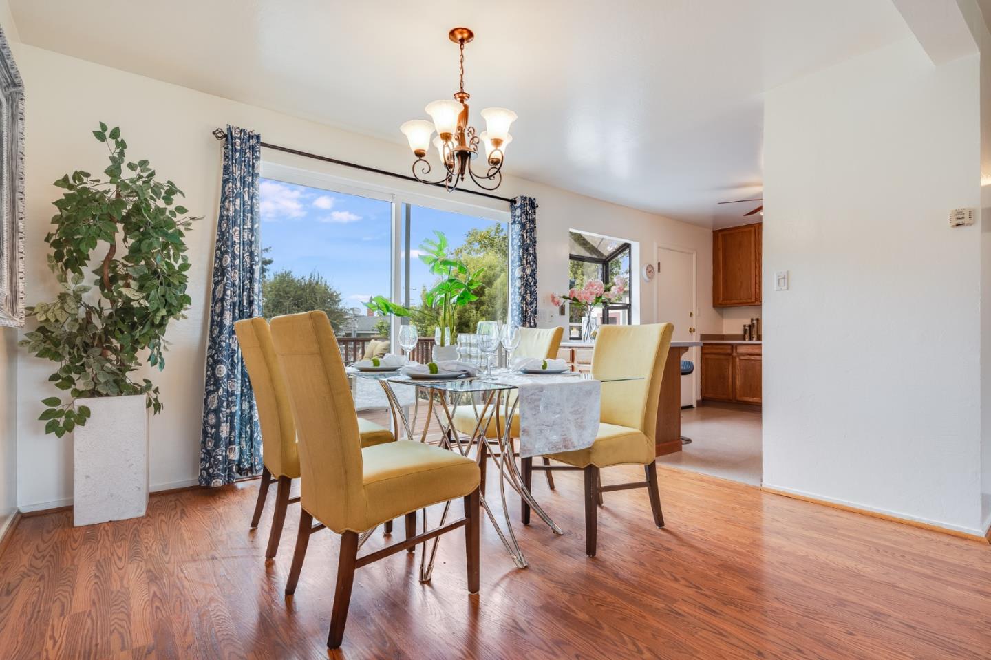 1376 Peralta Road Pacifica, CA 94044 - Photo 7 of 35 a dining room with furniture a chandelier and wooden floor