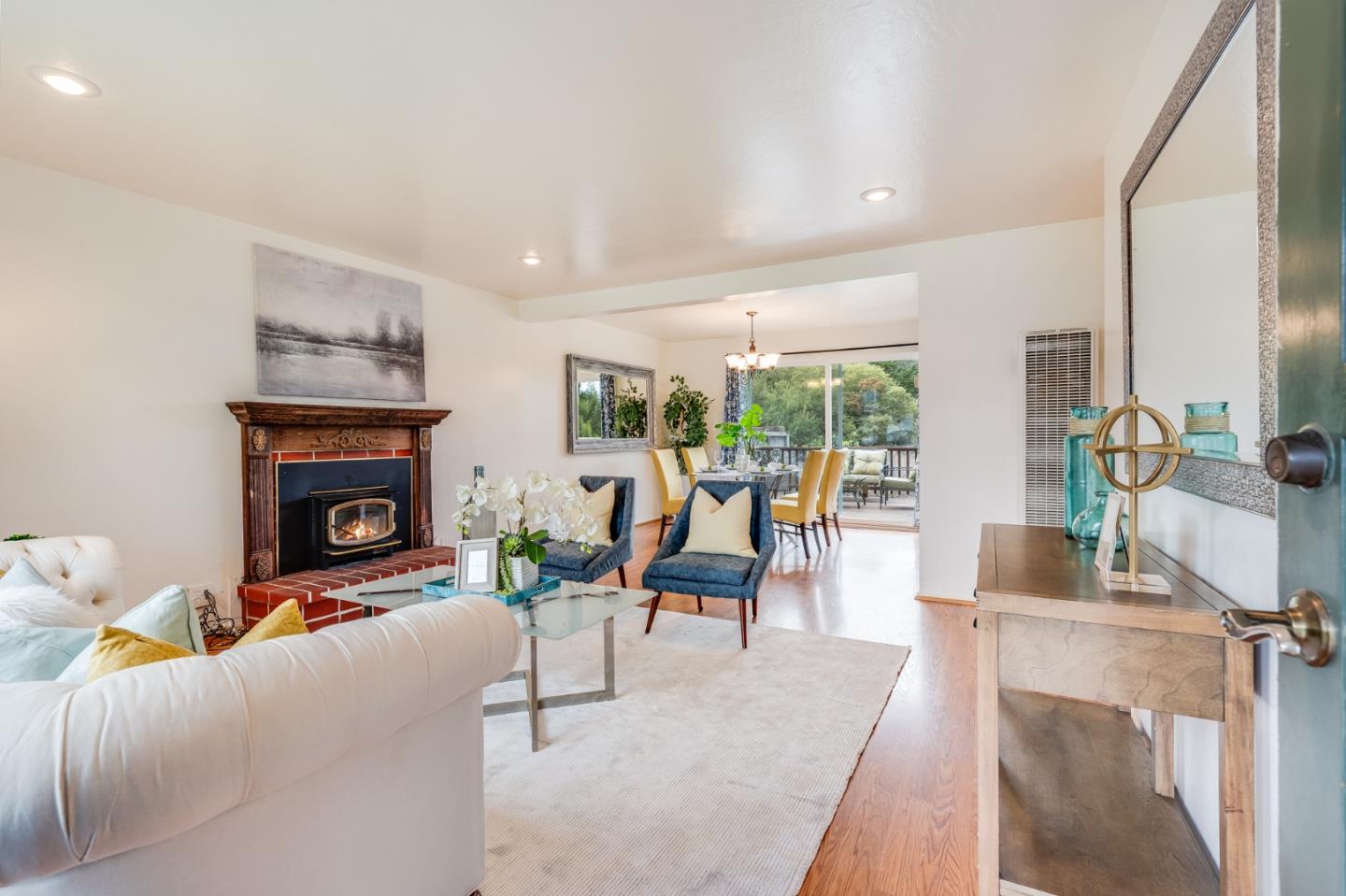 1376 Peralta Road Pacifica, CA 94044 - Photo 10 of 35 a living room with furniture a fireplace and a floor to ceiling window