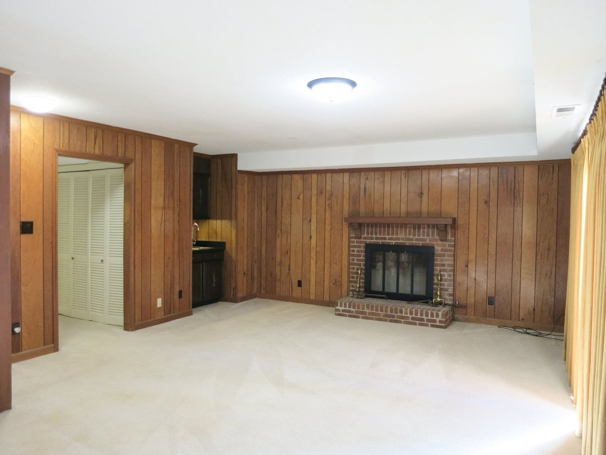 5809 Old Forge Circle Raleigh, NC 27609 - Photo 12 of 25 The big Lower Level Family Rm features a brick wood burning FP, wet bar w/cabinets, neutral carpet & sliders to the lg lower level Patio. Family Room