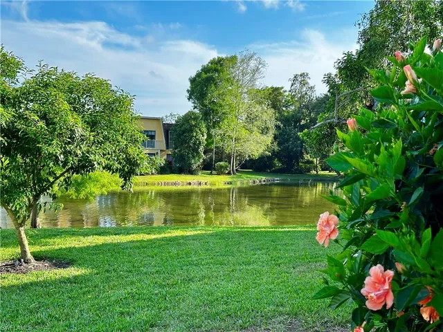 a view of a lake with a house in the background