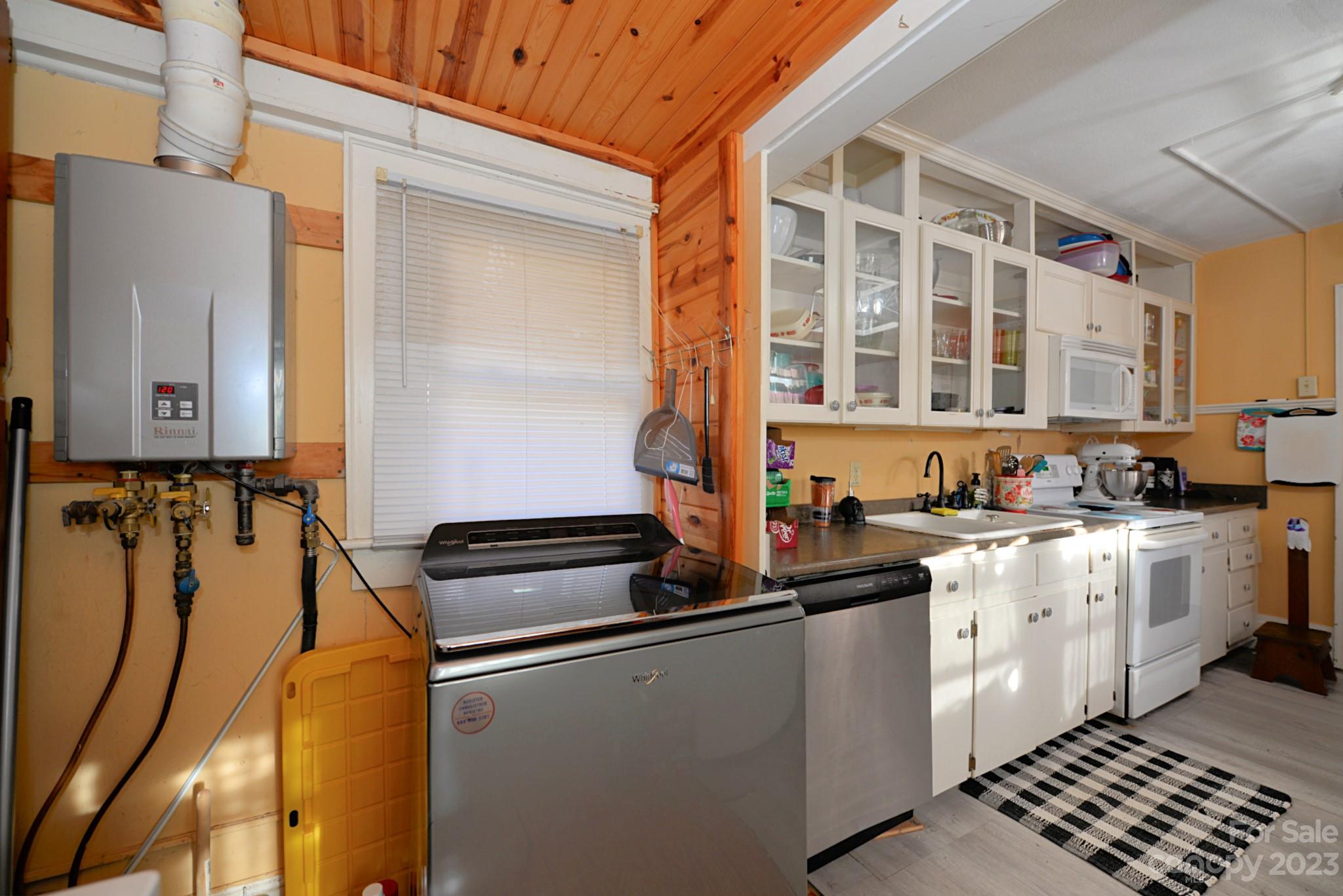 160 Edwards Road Clyde, NC 28721 - Photo 8 of 17 a kitchen with stainless steel appliances a sink and cabinets