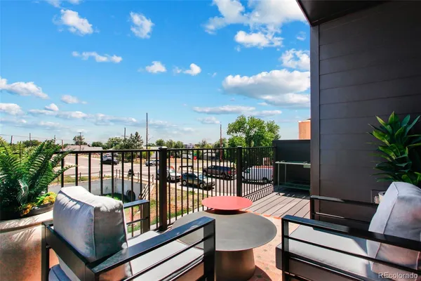 a view of a patio with couches table and chairs and potted plants