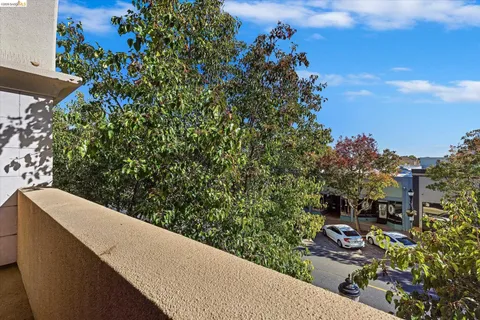 a view of city from balcony with seating space