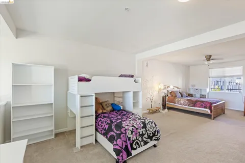 a bedroom with a bed and a chair