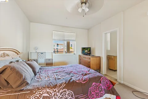 a bedroom with a bed and a dresser in it