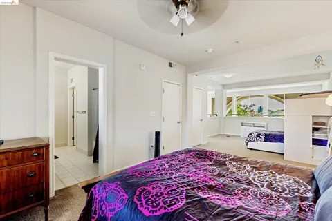 a bedroom with a bed dresser and a window