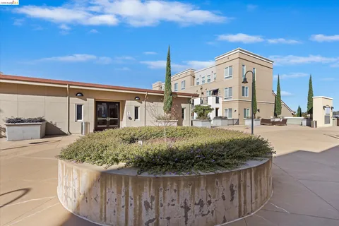 a view of a house with a wooden fence