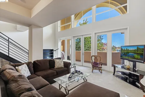 a living room with furniture and a floor to ceiling window