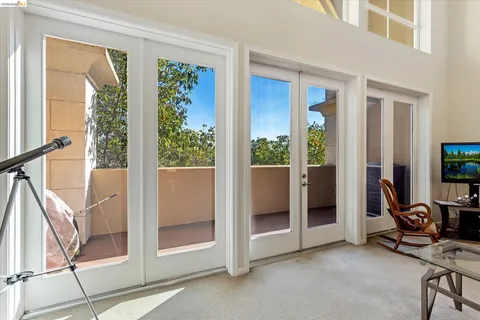 a view of a livingroom with furniture and floor to ceiling window