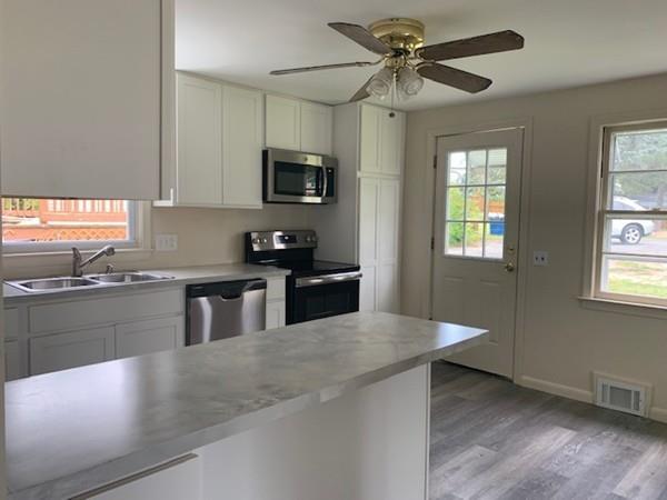 53 Moss Road Springfield, MA 01119 - Photo 4 of 15 a kitchen with stainless steel appliances granite countertop a sink a stove top oven a counter space and cabinets