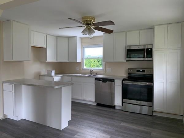 53 Moss Road Springfield, MA 01119 - Photo 6 of 15 a kitchen with stainless steel appliances a stove a sink and a microwave