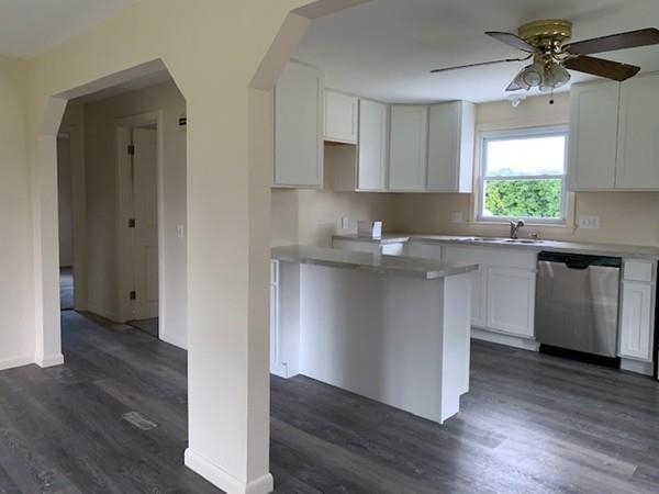 53 Moss Road Springfield, MA 01119 - Photo 7 of 15 a kitchen with stainless steel appliances granite countertop a sink a stove a refrigerator and island with wooden floor