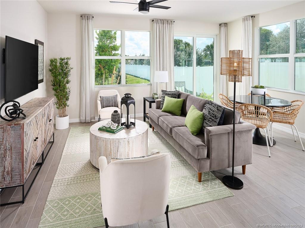 5698 Southeast Edgewater Circle Stuart, FL 34997 - Photo 5 of 8 a living room with furniture and a flat screen tv